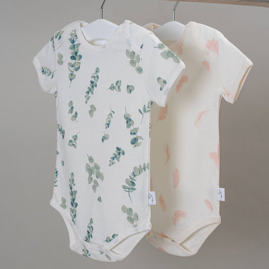 Baby onesie with eucalyptus leaf pattern on a white background