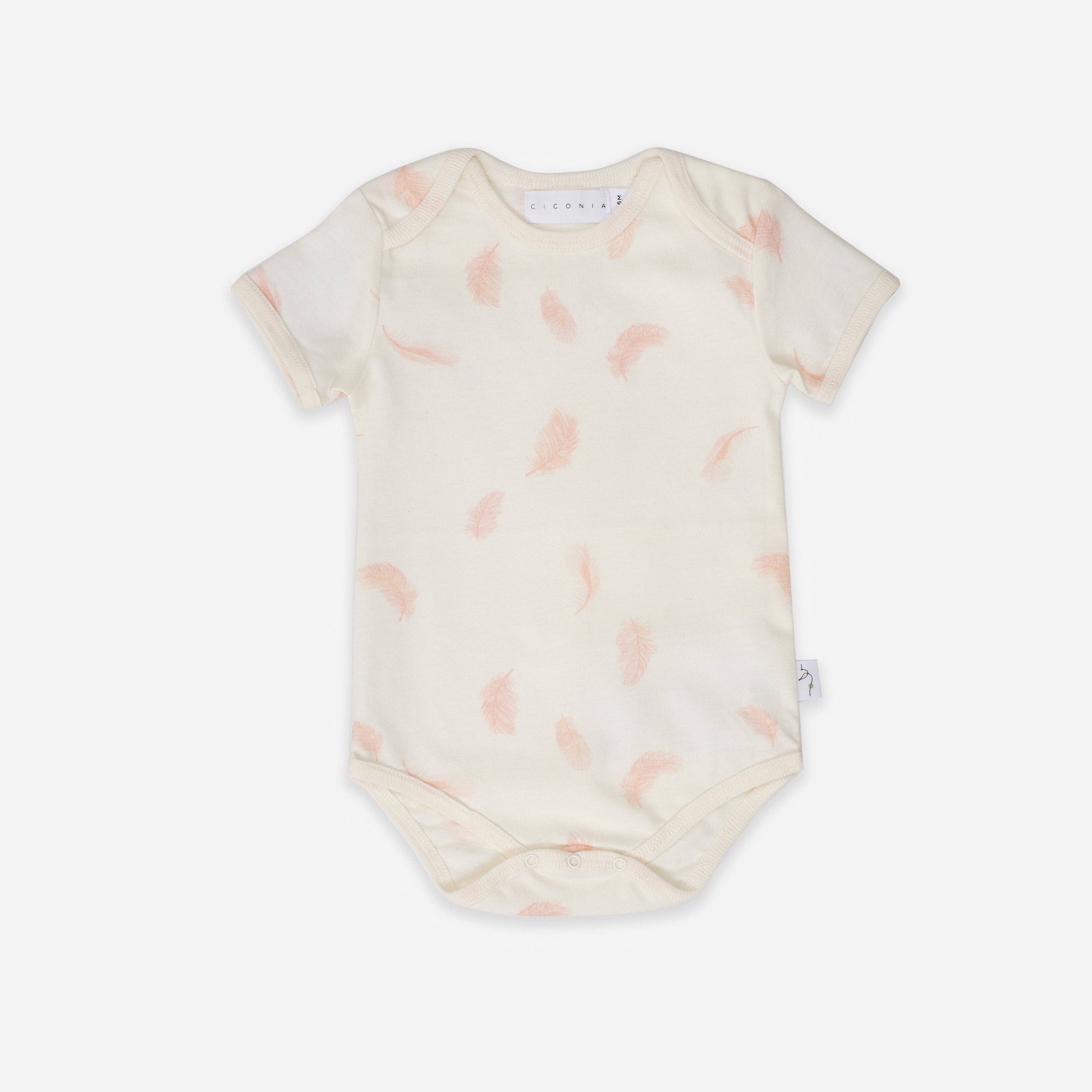 Baby onesie with pink abstract pattern on a white background