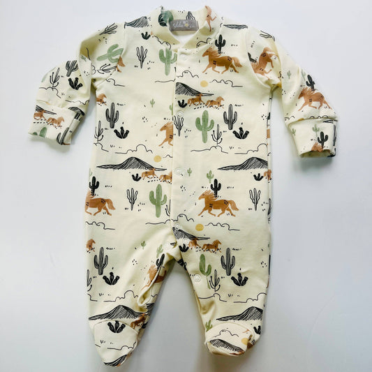 Baby sleepsuit with desert animal pattern on a light gray background