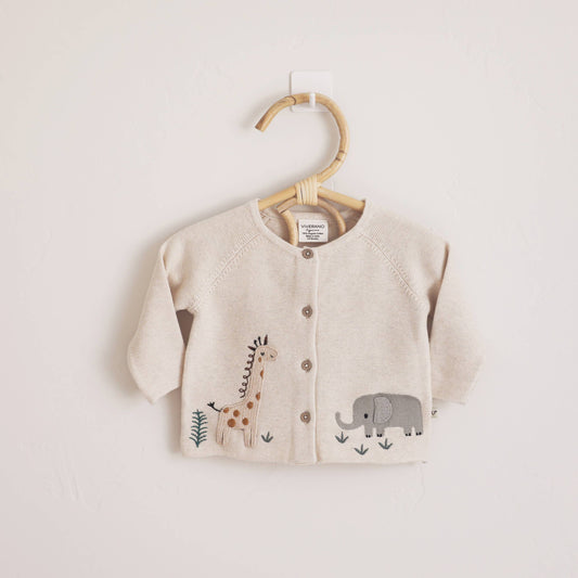 Baby cardigan with animal illustrations on a hanger against a light background