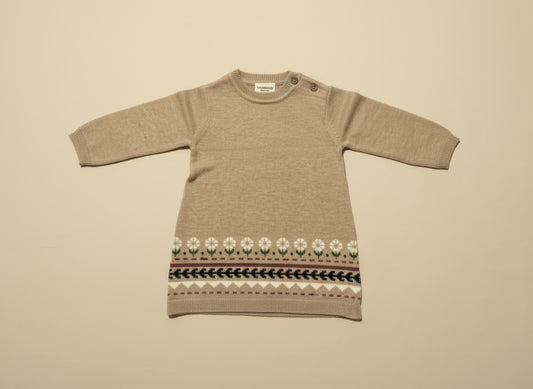 Brown knit dress with a patterned hem on a beige background