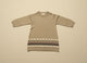 Brown knit dress with a patterned hem on a beige background