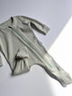 Green ribbed baby romper on a light gray background