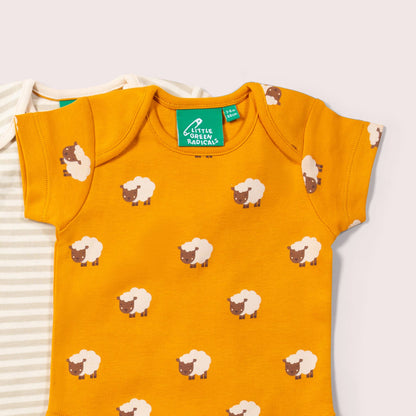 Yellow bodysuit with sheep pattern and 'Little Green Radicals' brand on a white background