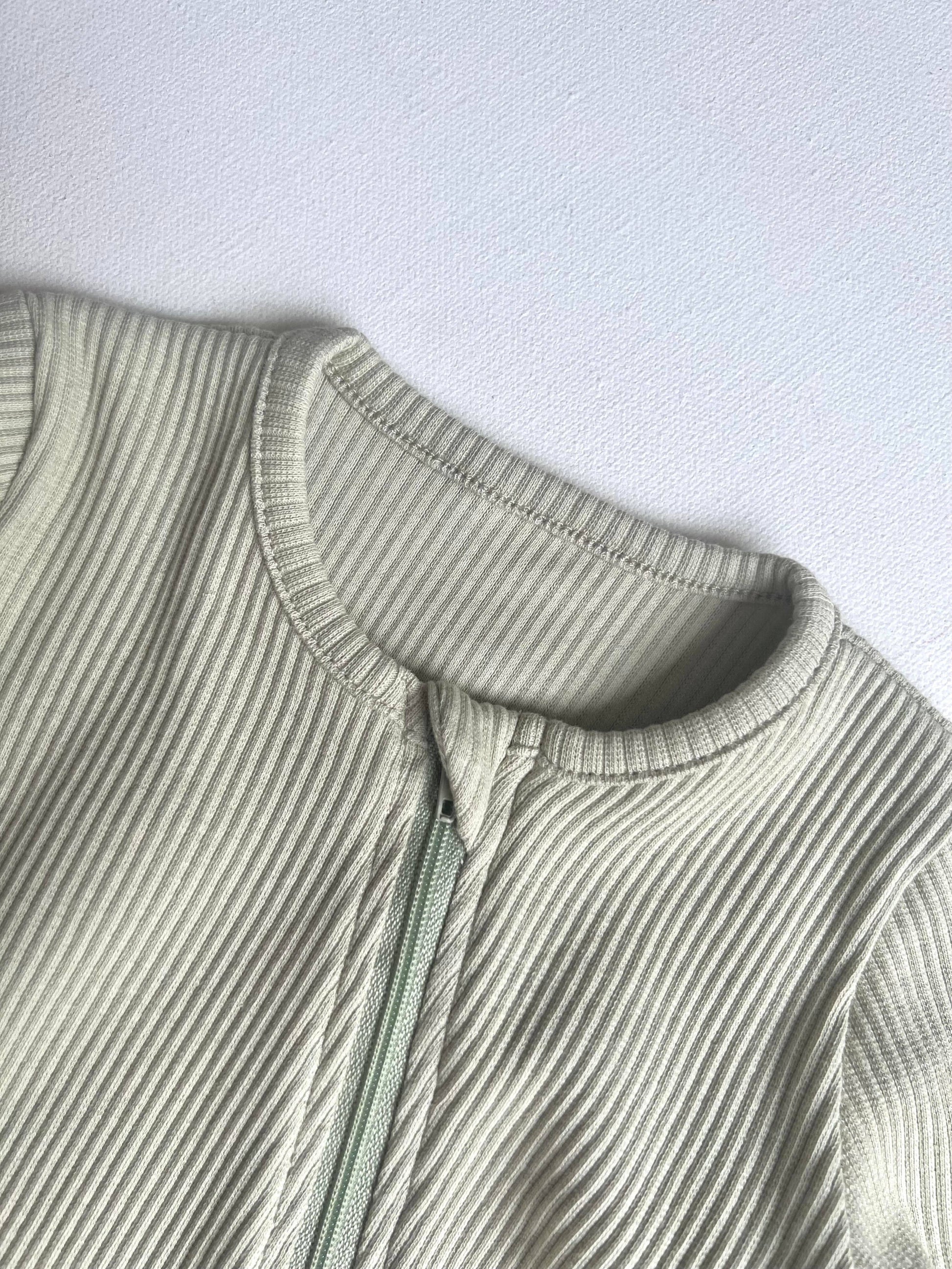Close-up of a ribbed knit romper on a light gray background