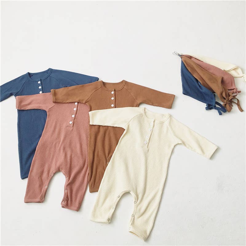 Four baby rompers in blue, brown, pink, and beige on a white background