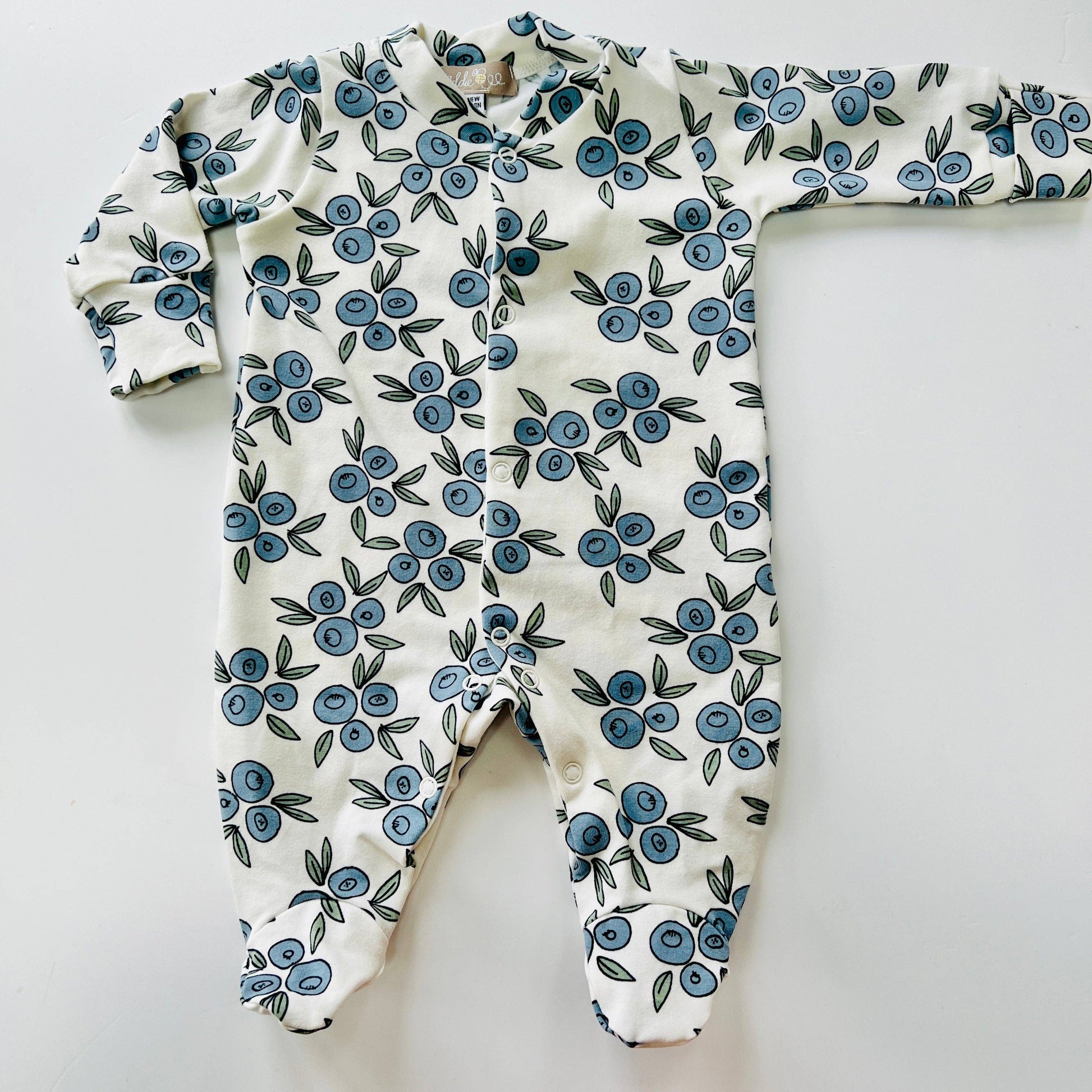 Baby sleepsuit with blue floral pattern on a white background