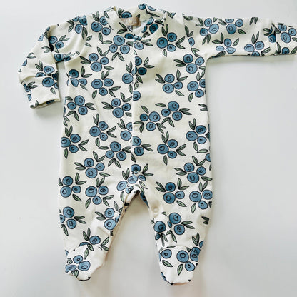 Baby sleepsuit with blue floral pattern on a white background