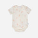 Baby onesie with pink abstract pattern on a white background