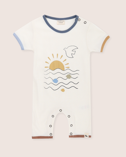 Baby's romper with a sun and wave design on a plain background