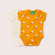 Yellow baby bodysuit with sheep pattern on a light gray background