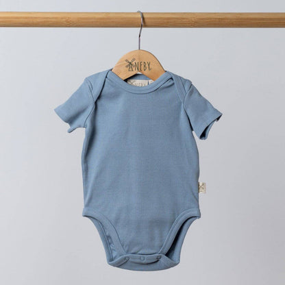 Blue baby bodysuit on a wooden hanger against a light gray background