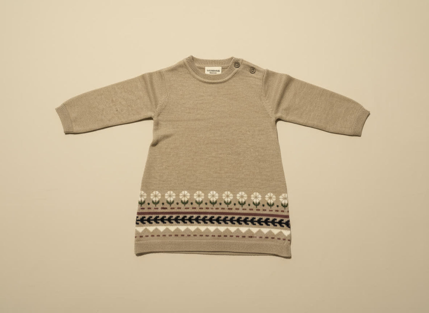 Brown knit dress with a patterned hem on a beige background